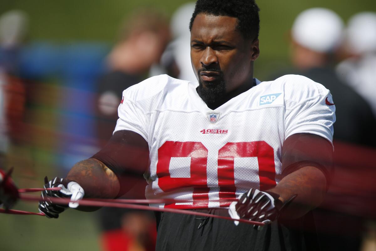 San Francisco 49ers defensive tackle Darnell Dockett stretches before a scrimmage against the Denver Broncos on Aug. 26.