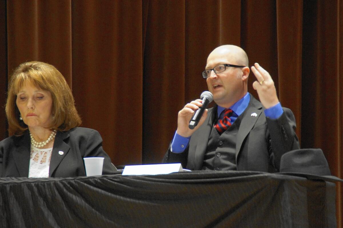 Assemblyman Matthew Harper (R-Huntington Beach) talks about regulatory efforts on the sober-living industry during a town hall meeting Thursday in Laguna Hills. State Sen. Pat Bates (R-Laguna Niguel), left, also spoke.