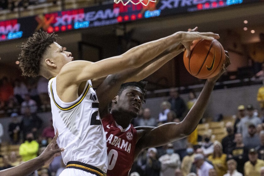 Missouri's Trevon Brazile, left, and Alabama's Charles Bediako, right, battle for a rebound during the first half of an NCAA college basketball game Saturday, Jan. 8, 2022, in Columbia, Mo. (AP Photo/L.G. Patterson)