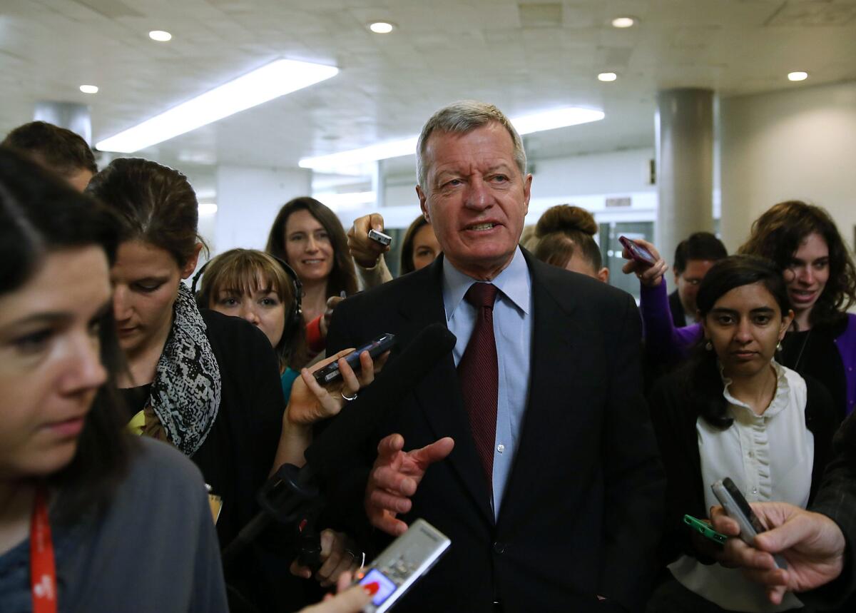 Sen. Max Baucus (D-Mont.) is trailed by reporters Tuesday on Capitol Hill in Washington. Baucus announced that he will not seek reelection in 2014.