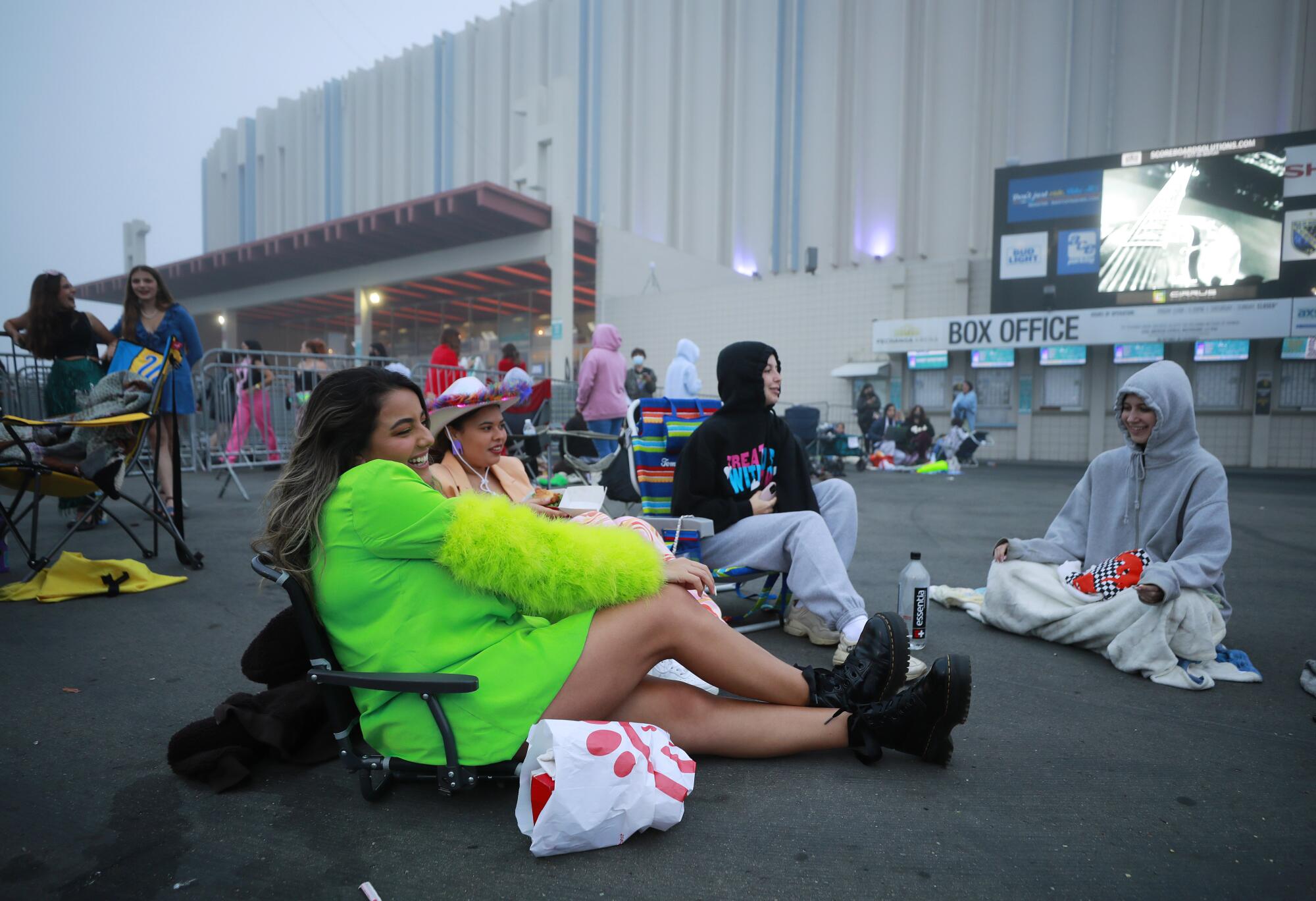Fans wait in line hoping to get tickets to the sold-out Harry Styles concert. Some of them spent the night.