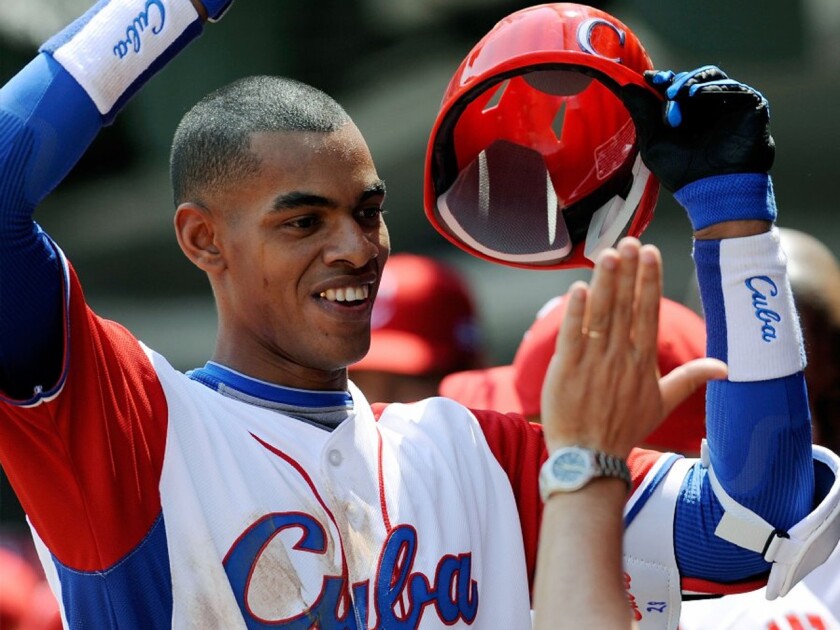 Newly acquired Hector Olivera will have a friendly face with the Dodgers. Yasiel Puig took hitting insructors from Olivera's father.