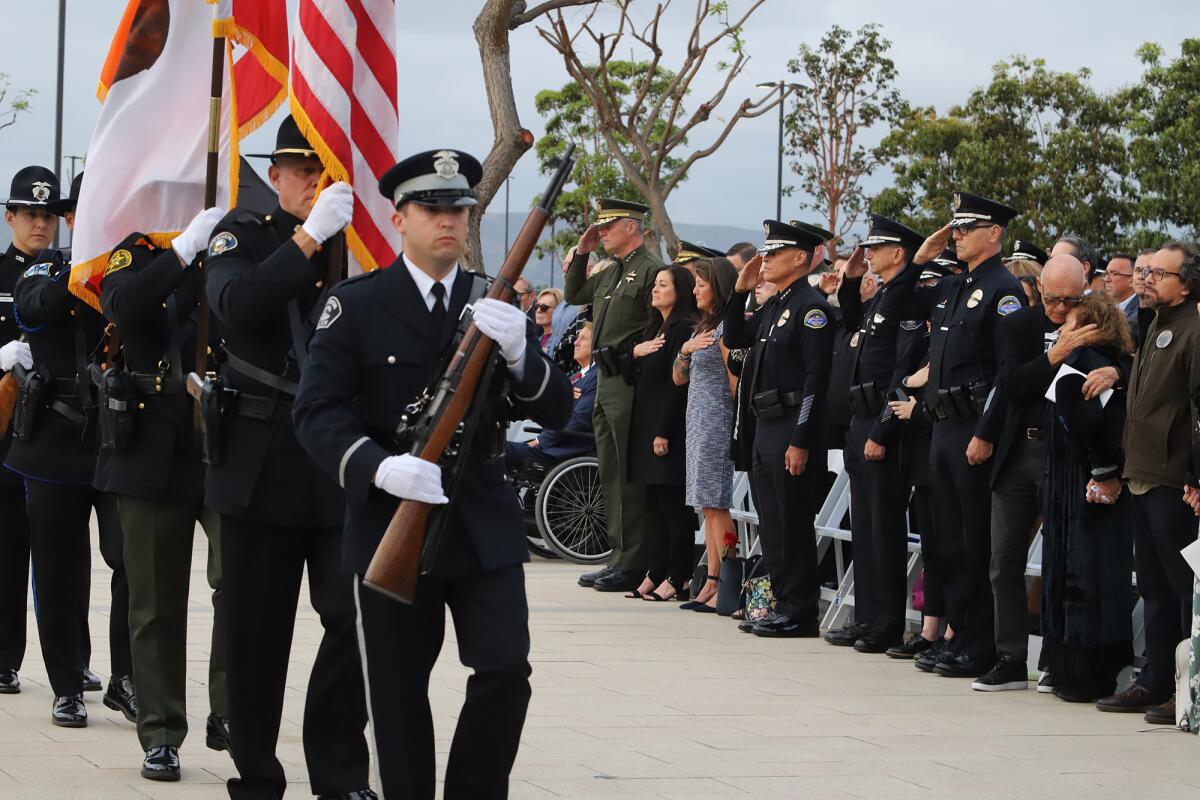 Orange County police officers and the family of Nick Vella stand for the presentation of the colors.