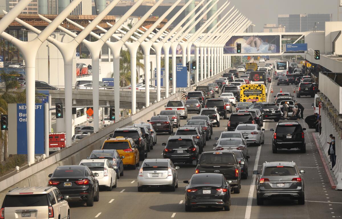 Vehicles crowd the departure drop-off lanes on the "horseshoe" road at LAX in 2021. 