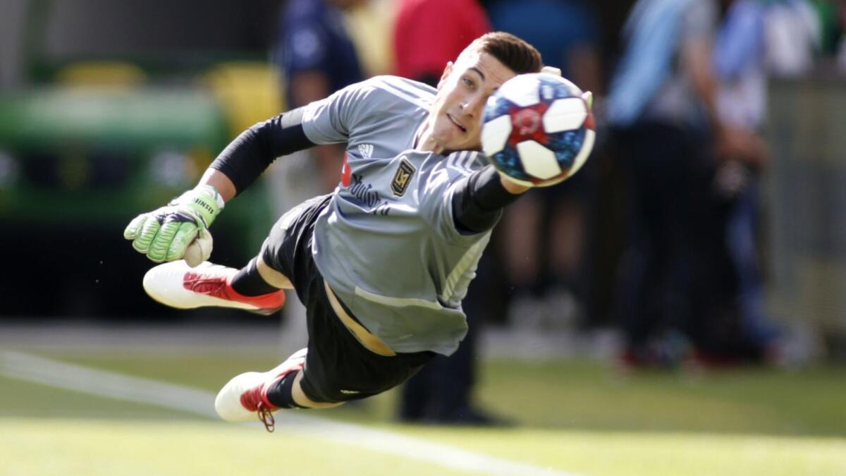 LAFC goalkeeper Pablo Sisniega makes a save during a warm up exercise ahead of a game against the Seattle Sounders in April 2019.