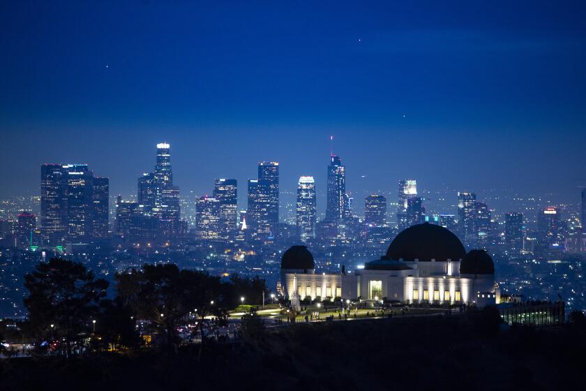 LOS ANGELES, CA - December 20 2021: Dusk settles in over the city in a view from above the Griffith Park Observatory toward downtown Los Angeles on Monday, Dec. 20, 2021 in Los Angeles, CA. (Brian van der Brug / Los Angeles Times