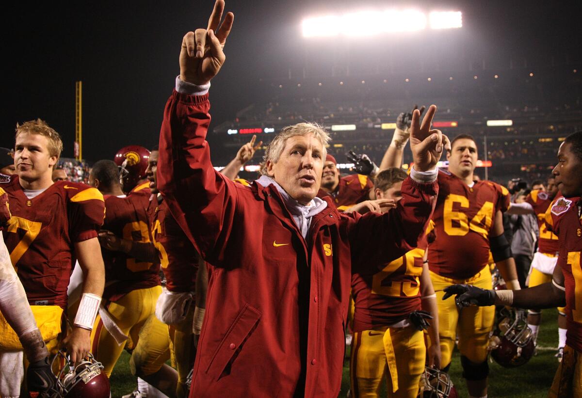 USC coach Pete Carroll celebrates after a win over Boston College in the Emerald Bowl on Dec. 26, 2009.