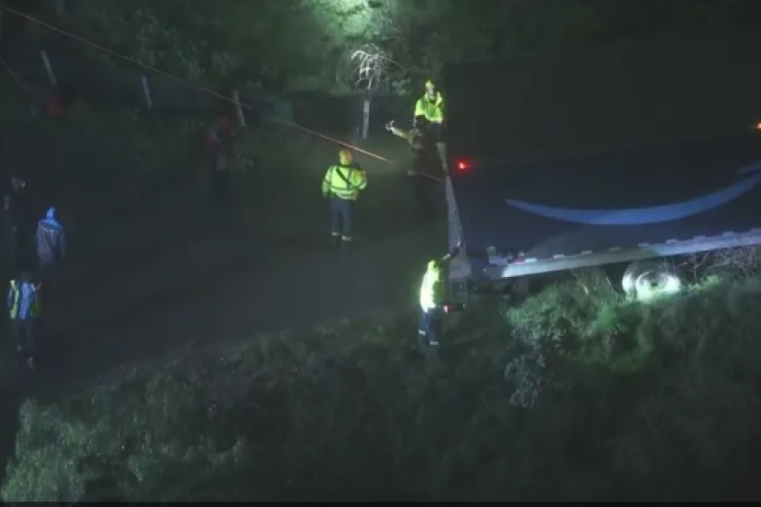 A delivery truck is perched precariously on the side of a hill near Montecito Heights on Monday night.