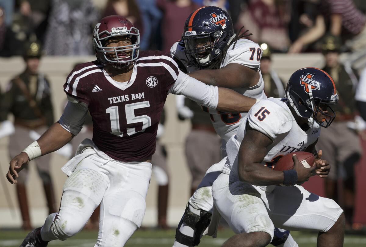 Unlike Leonard Fournette and Christian McCaffrey, Texas A&M defensive lineman Myles Garrett, left, seen making a one-handed sack against UTSA, is a top prospect who chose to play in his team's bowl game.