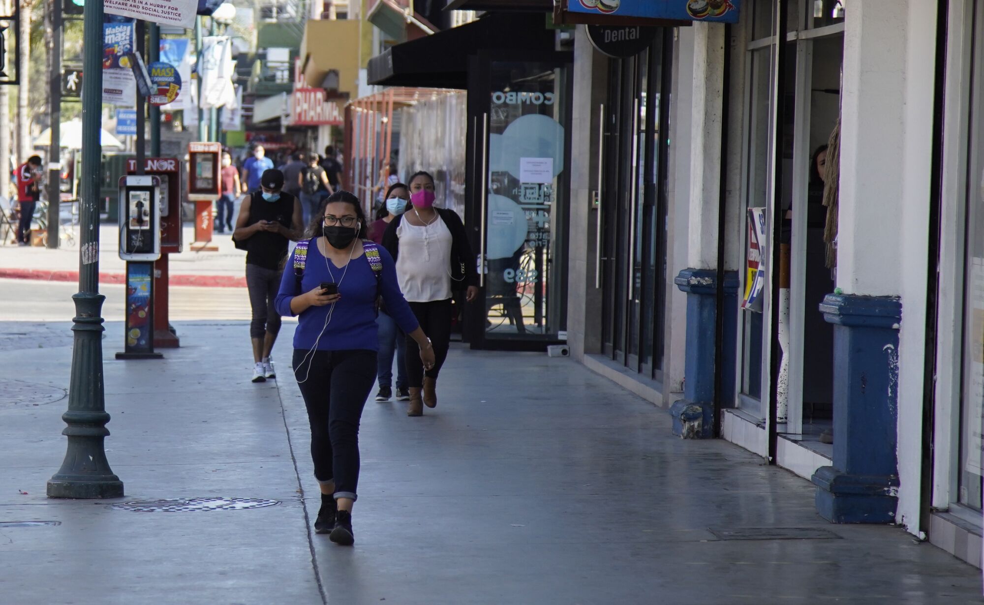  People wearing masks to protect against the coronavirus walk along Avenida Revolución in June 2020.