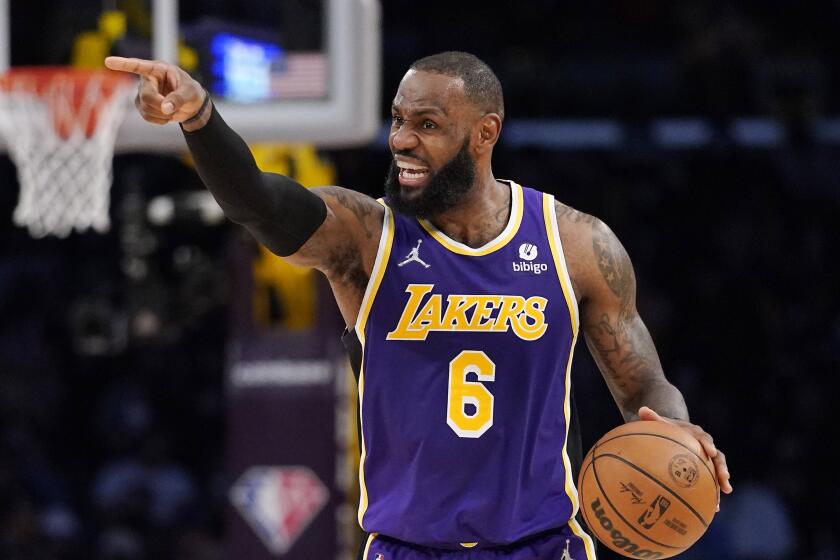 Los Angeles Lakers forward LeBron James gestures during the second half of an NBA basketball game.