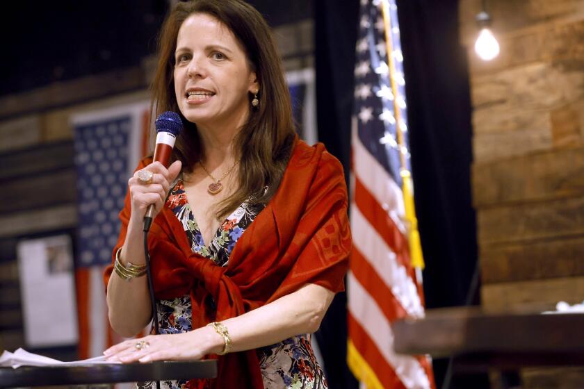 FILE - Dr. Simone Gold speaks to a large crowd inside The Elephant in the Room in Jenks during a Frontline Doctor's Uncensored Truth Tour event on Wednesday, June 30, 2021.(John Clanton/Tulsa World via AP, File)