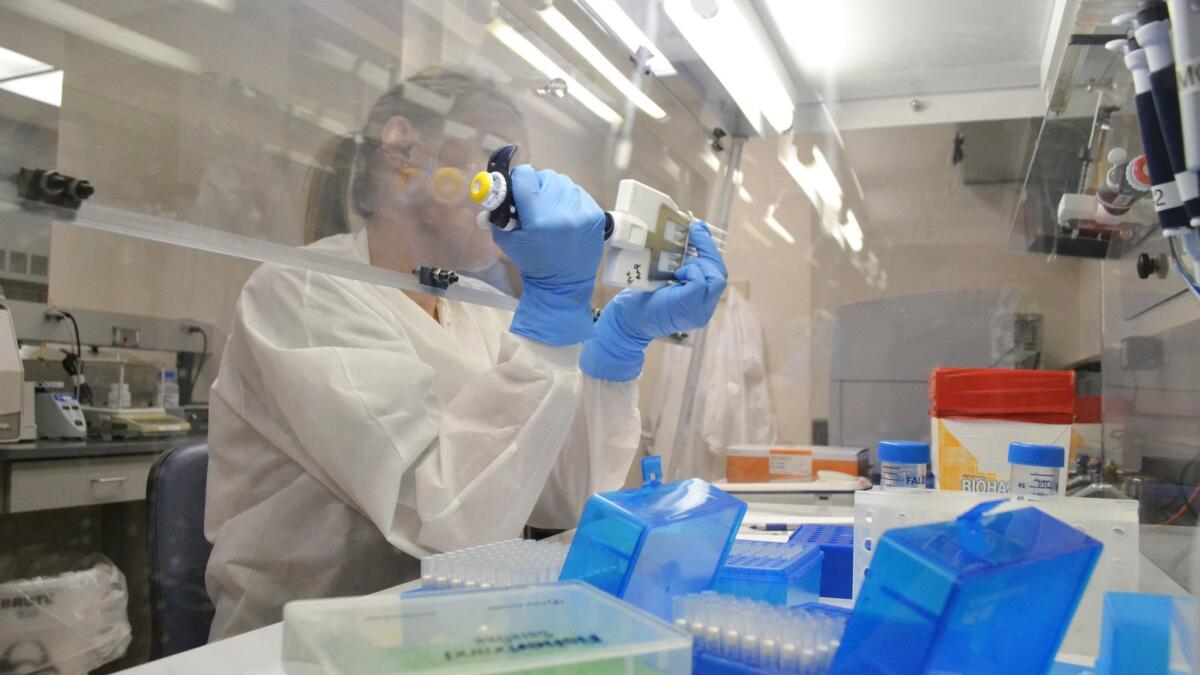 A technician at a Colorado Department of Public Health & Environment lab in Denver extracts DNA for whole genome sequencing. Such testing could revolutionize everything from medical care to agriculture.