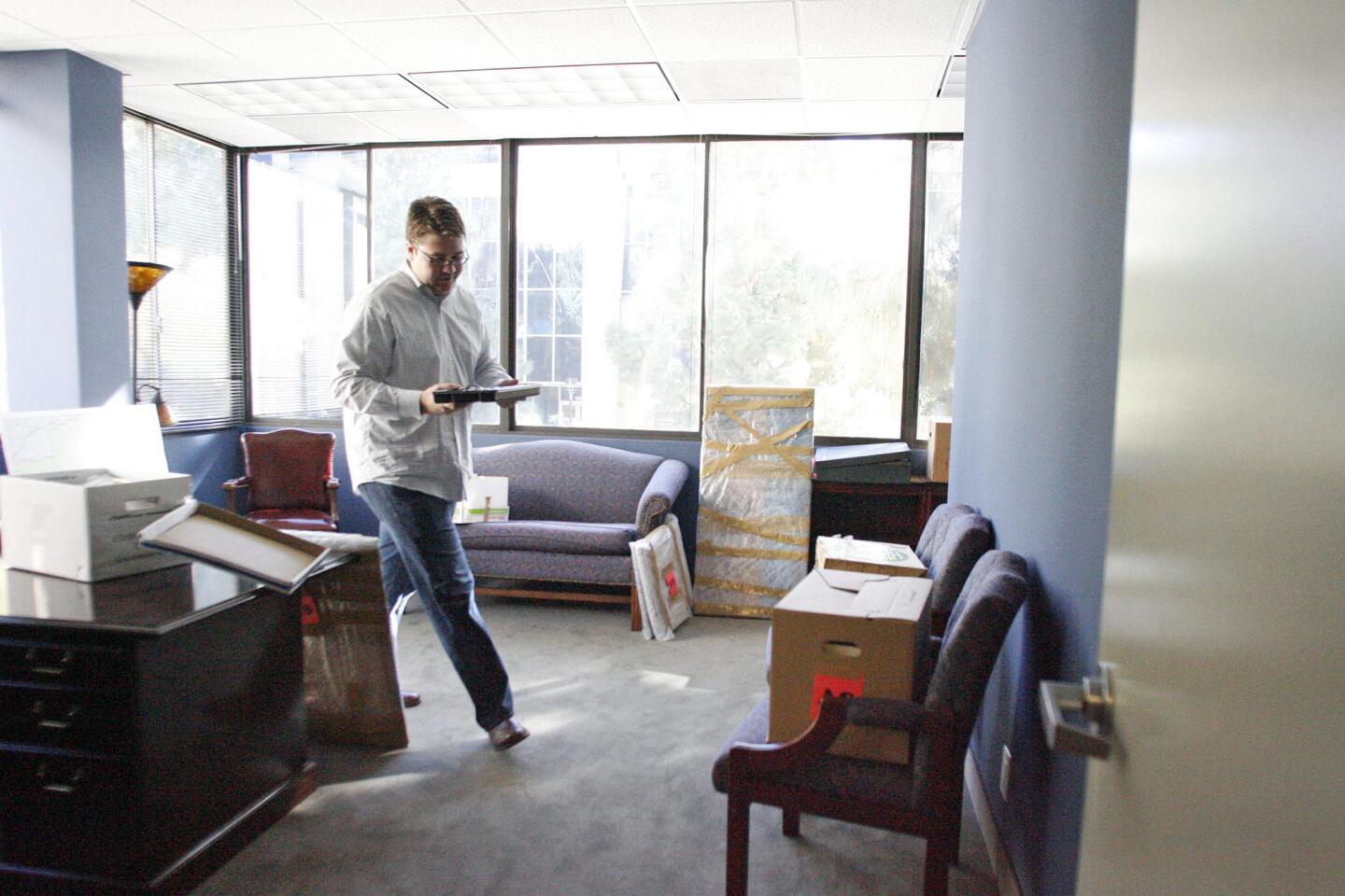 Patrick Boland helps unpack boxes in the new office for Rep. Adam Schiff in Burbank on Thursday, December 27, 2012.