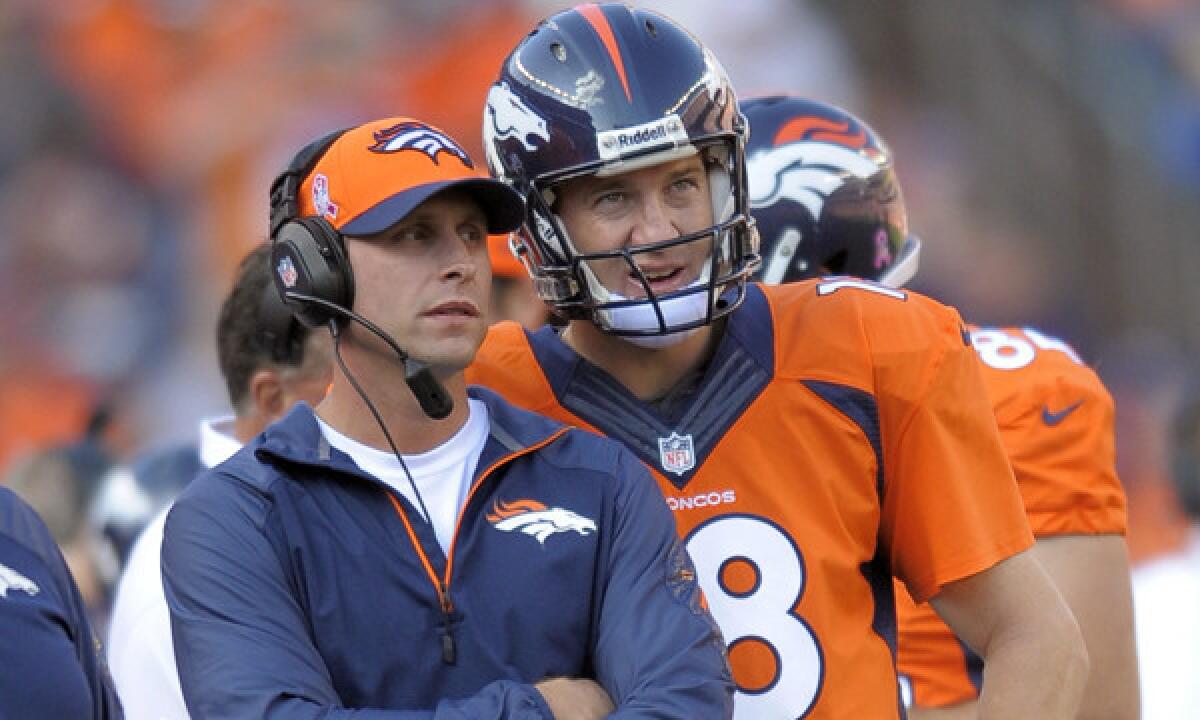 Denver Broncos offensive coordinator Adam Gase speaks with quarterback Peyton Manning during a game against the Jacksonville Jaguars in October. Gase is no longer interested in the Cleveland Browns' coaching job.