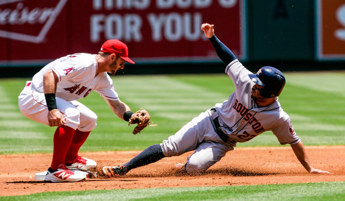 Jose Altuve of the Houston Astros steals second base in the first inning ahead of a throw to Angels second baseman Johnny Giavotella at Angel Stadium.