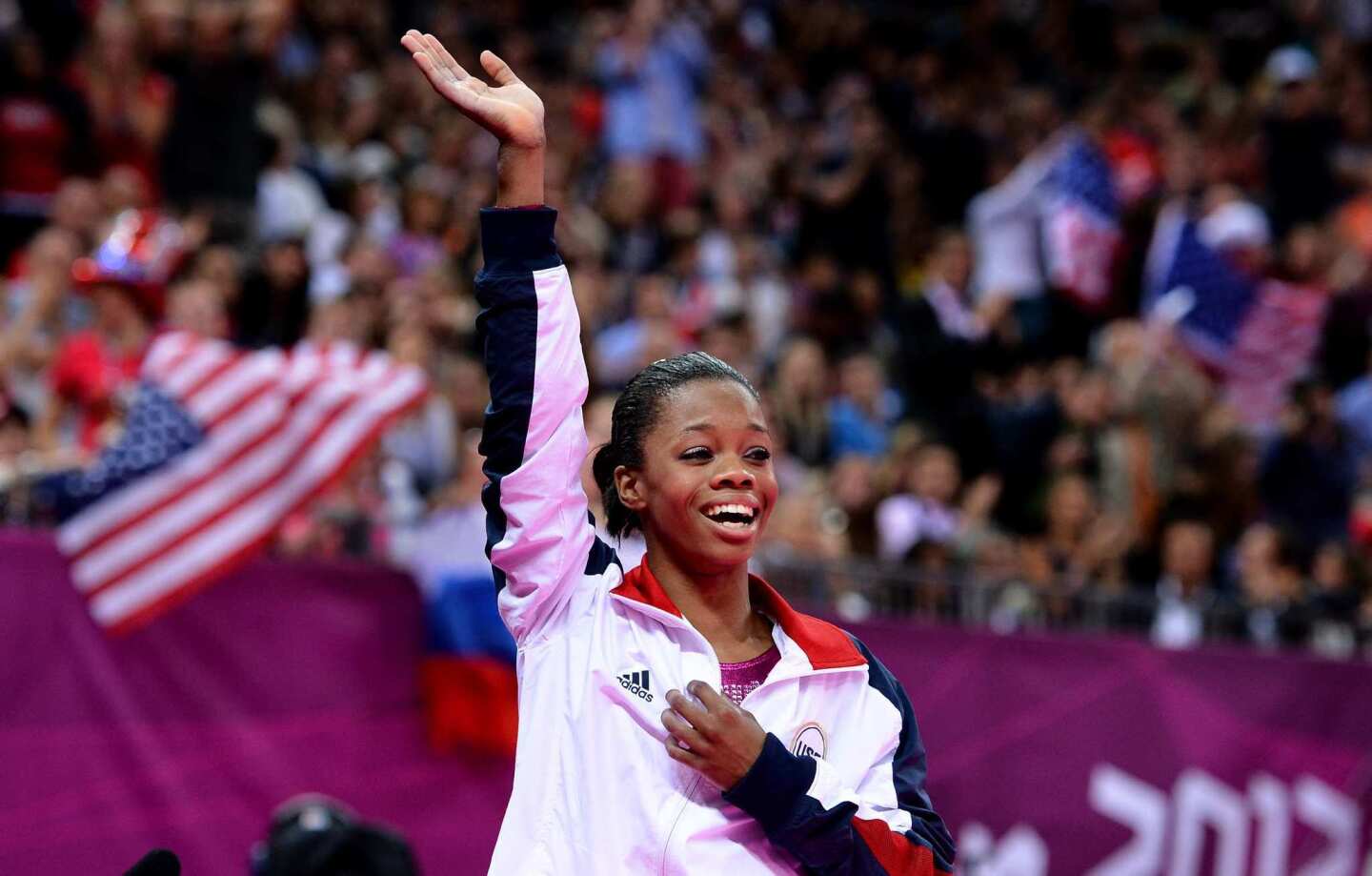 Gabrielle Douglas waves to the crowd after winning the gold medal in the women's individual all-around at the 2012 London Olympics.