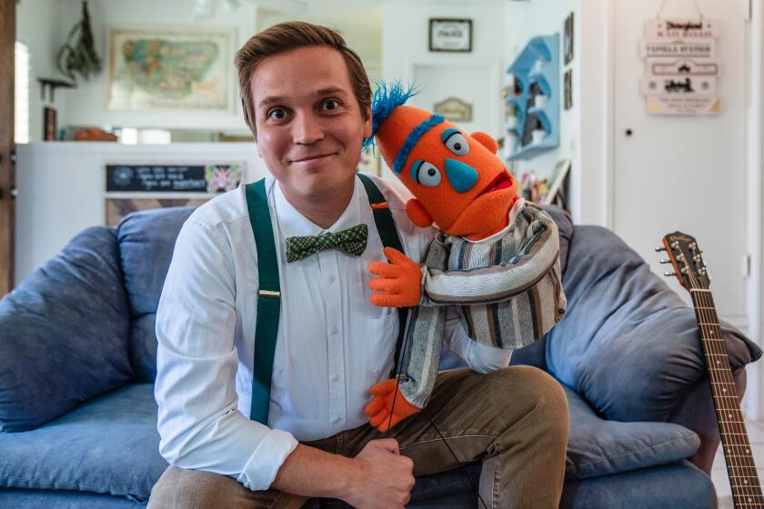 Tyler Tafolla a Southern California-based composer, lyricist and librettist, and puppet Bort at home in Point Loma on May 8, 2024. (Ariana Drehsler/For The San Diego Union-Tribune)