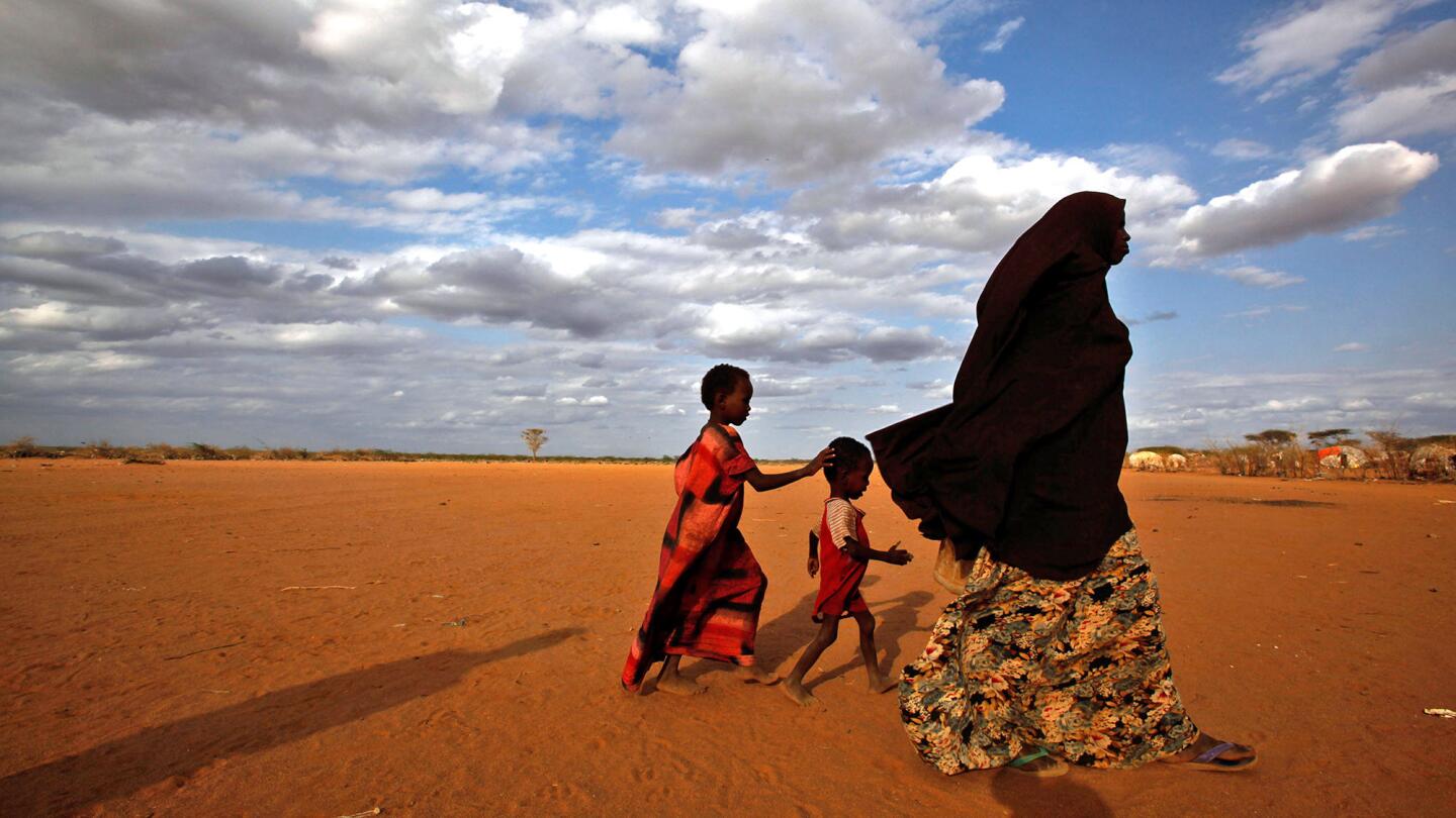 A Somali woman and her children walk toward the outskirts of the Dagahaley camp, part of the Dadaab refugee complex in Kenya. Dadaab's camps house more than 356,000 refugees.