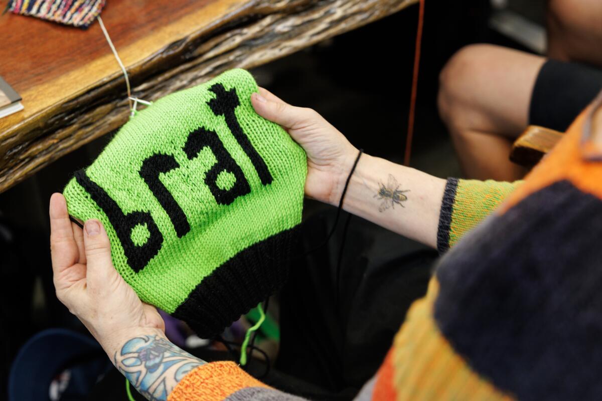 Annette Corsino, owner of Knitting Tree LA, works on a hat called "Golf club" in 