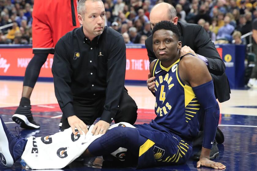 INDIANAPOLIS, INDIANA - JANUARY 23: Victor Oladipo #4 of the Indiana Pacers is attended to by medical staff after being injured in the second quarter of the game against the Toronto Raptors at Bankers Life Fieldhouse on January 23, 2019 in Indianapolis, Indiana. (Photo by Andy Lyons/Getty Images) ** OUTS - ELSENT, FPG, CM - OUTS * NM, PH, VA if sourced by CT, LA or MoD **