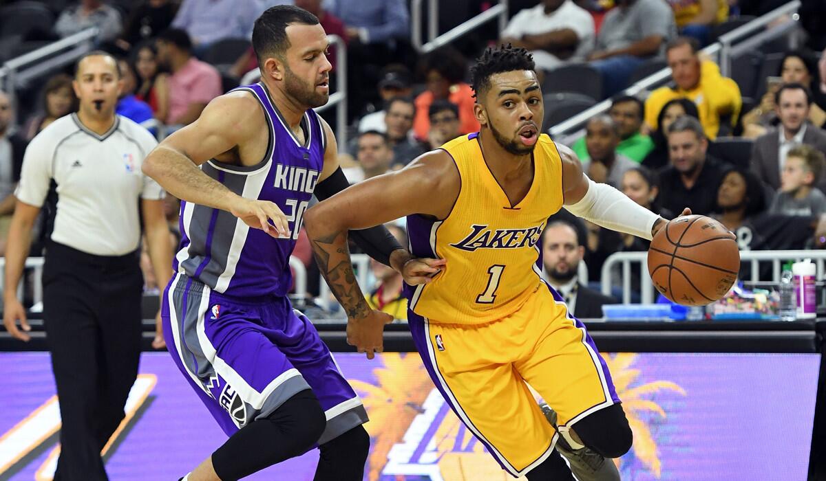 Lakers' D'Angelo Russell, right, drives against Sacramento Kings' Jordan Farmar during a preseason game on Oct. 13.