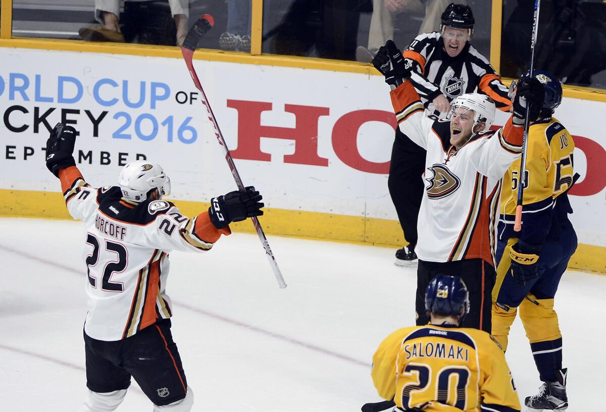 Ducks forward Jamie McGinn, second from right, celebrates with Shawn Horcoff (22) after McGinn scored a goal against the Nashville Predators during the second period of Game 4.
