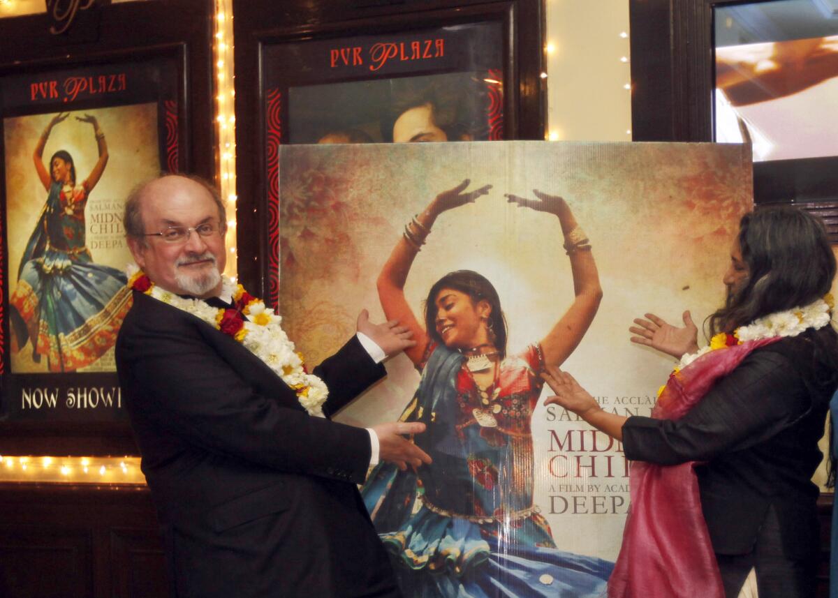 Rushdie, left, and director Deepa Mehta before a screening of 'Midnight's Children' at a movie hall in India, 2013.