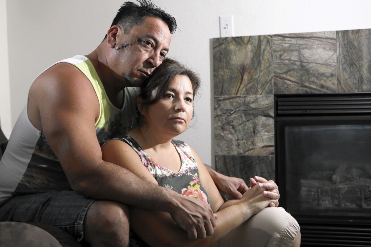 Anthony, left, and Cynthia Hernandez at their home in Chino. Both of them were stabbed by their mentally ill son, Aaron; the scar from the attack on Anthony is visible on his face.