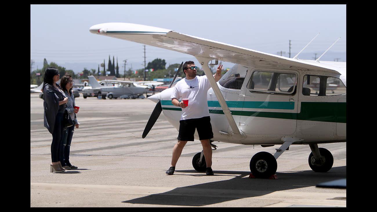 Student pilot Rashid Shakirov, right, shows a Cessna 172 to his mother Lana Shakirov, left, and his sister Madina, center, during the Glendale Community College Aviation Club open house, at the GCC Hanger, Whiteman Airport, in Pacoima on Saturday, June 30, 2018.