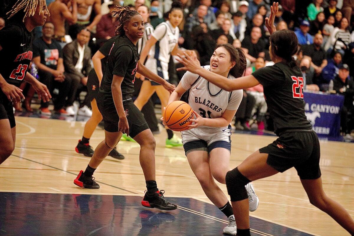 Sierra Canyon's Crystal Wang tries to split two Etiwanda defenders on a drive down the lane Tuesday night.