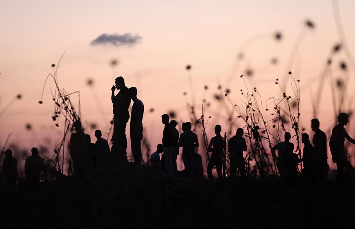 Palestinian youths clash with Israeli troops on the Nahel Oz border of Gaza City on Saturday.