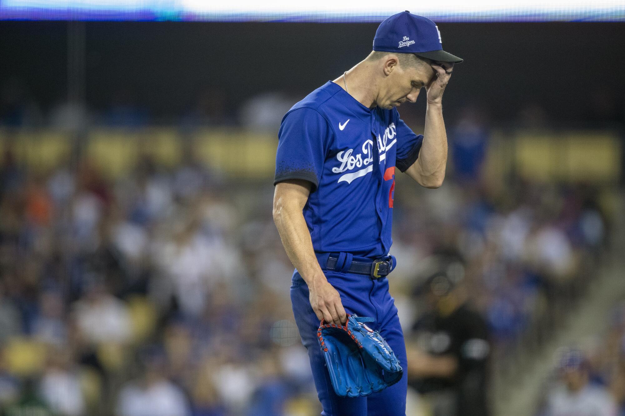 Dodgers pitcher Walker Buehler walks off the field at Dodger Stadium.