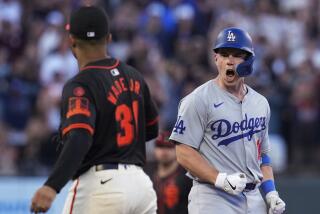 Los Angeles Dodgers' Will Smith, right, reacts after hitting a two-run double against.