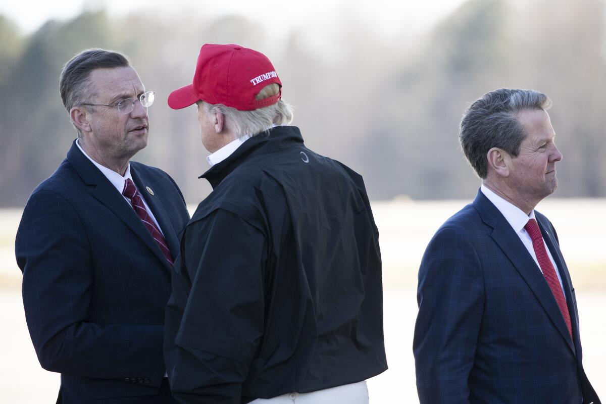 Rep. Doug Collins (R-Ga.), left, greets President Trump on Friday.