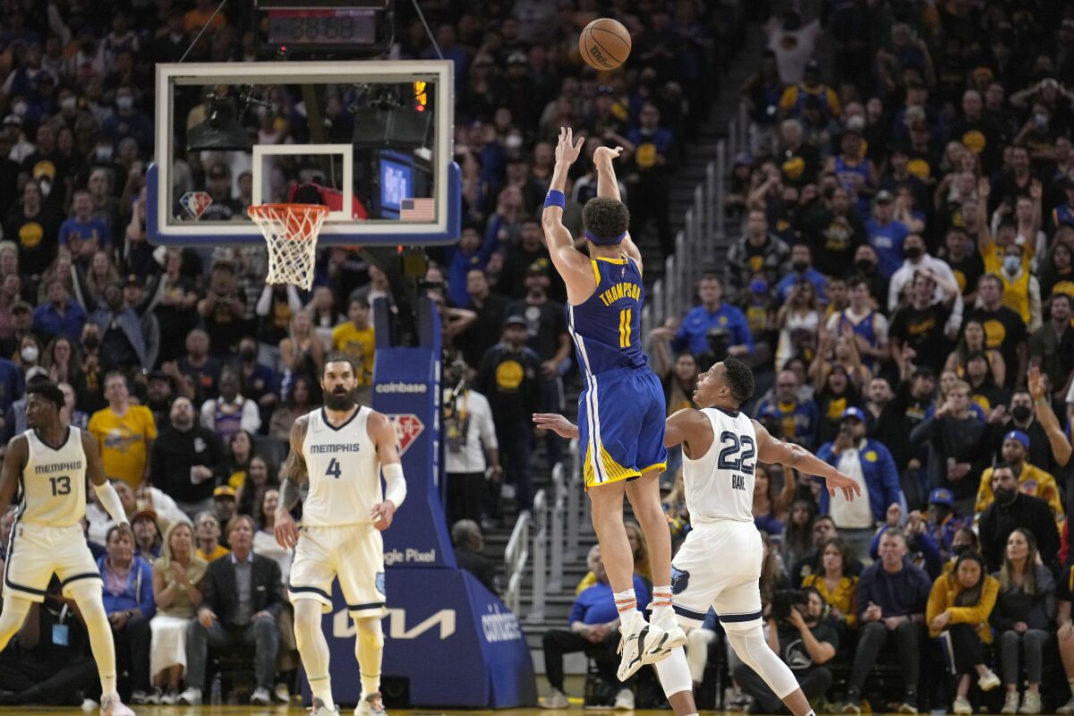 Golden State Warriors guard Klay Thompson (11) takes a 3-point shot over Memphis Grizzlies guard Desmond Bane (22) during the second half of Game 6 of an NBA basketball Western Conference playoff semifinal in San Francisco, Friday, May 13, 2022. The Warriors won 110-96 and advanced to the conference finals. (AP Photo/Tony Avelar)