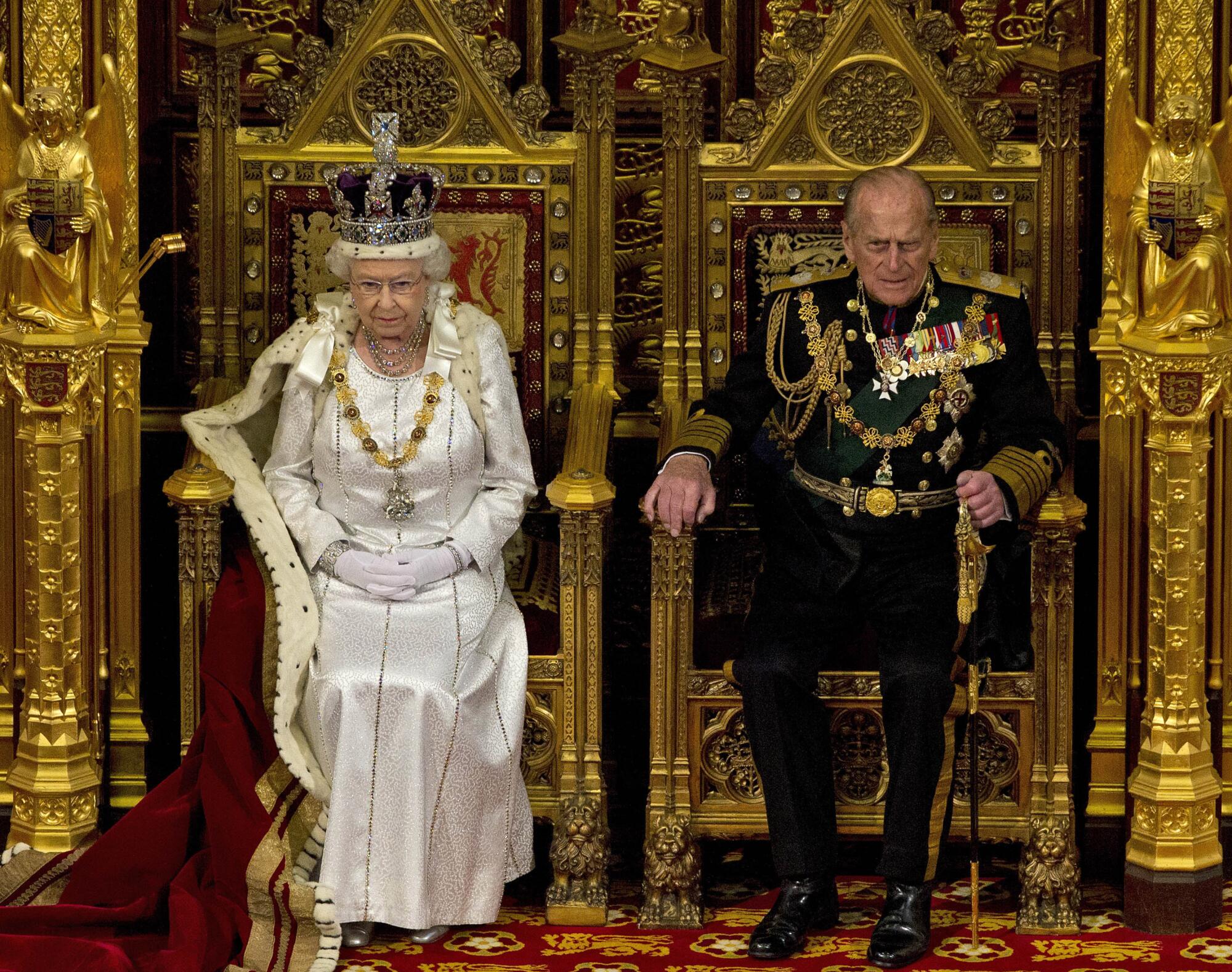 Queen Elizabeth II and Prince Philip in full regalia in the House of Lords