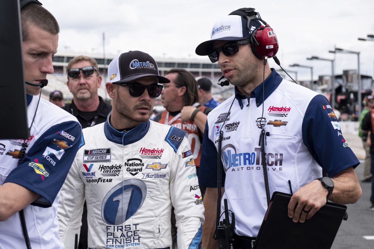 FILE - Kyle Larson, center, talks with his crew chief Cliff Daniels, right, before qualifying for the NASCAR Cup Series auto race at Charlotte Motor Speedway on Saturday, May 29, 2021 in Charlotte, N.C. Daniels, fresh off his first NASCAR championship as a crew chief, still isn’t getting much sleep. He’s in Nashville to celebrate the Cup title won with Kyle Larson and the No. 5 team while his wife is back in North Carolina expecting the birth of their second child at any moment. (AP Photo/Ben Gray, File)
