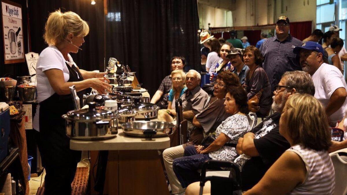 Fairgoers listen to a pitch for Lustre Craft cookware in 2015 at the Los Angeles County Fair in Pomona.