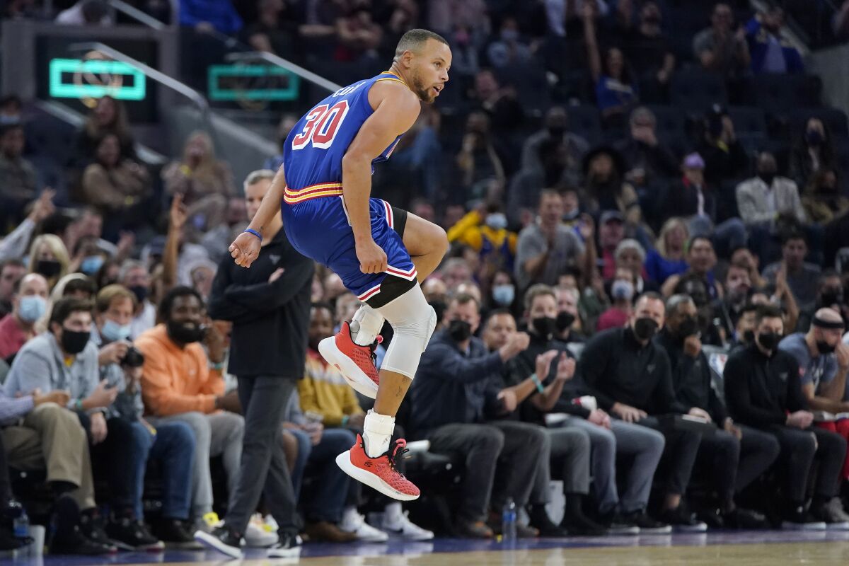 Golden State Warriors guard Stephen Curry reacts after shooting a 3-point basket during the second half of an NBA basketball game against the Chicago Bulls in San Francisco, Friday, Nov. 12, 2021. (AP Photo/Jeff Chiu)