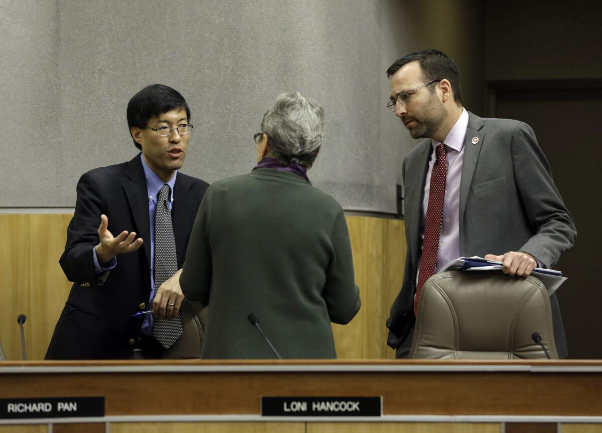 State Sen. Richard Pan (D-Sacramento), left, talks last week with Senate Education Committee member Loni Hancock (D-Berkeley) about the concerns she had about the measure he and Sen. Ben Allen (D-Santa Monica), right, co-authored, requiring California schoolchildren to get vaccinated.