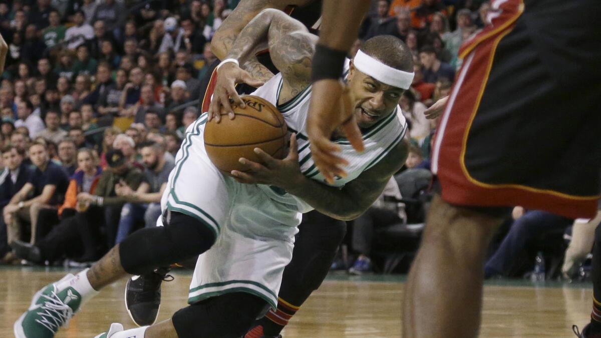 Celtics guard Isaiah Thomas drives the lane against the Heat during the first quarter Friday night.