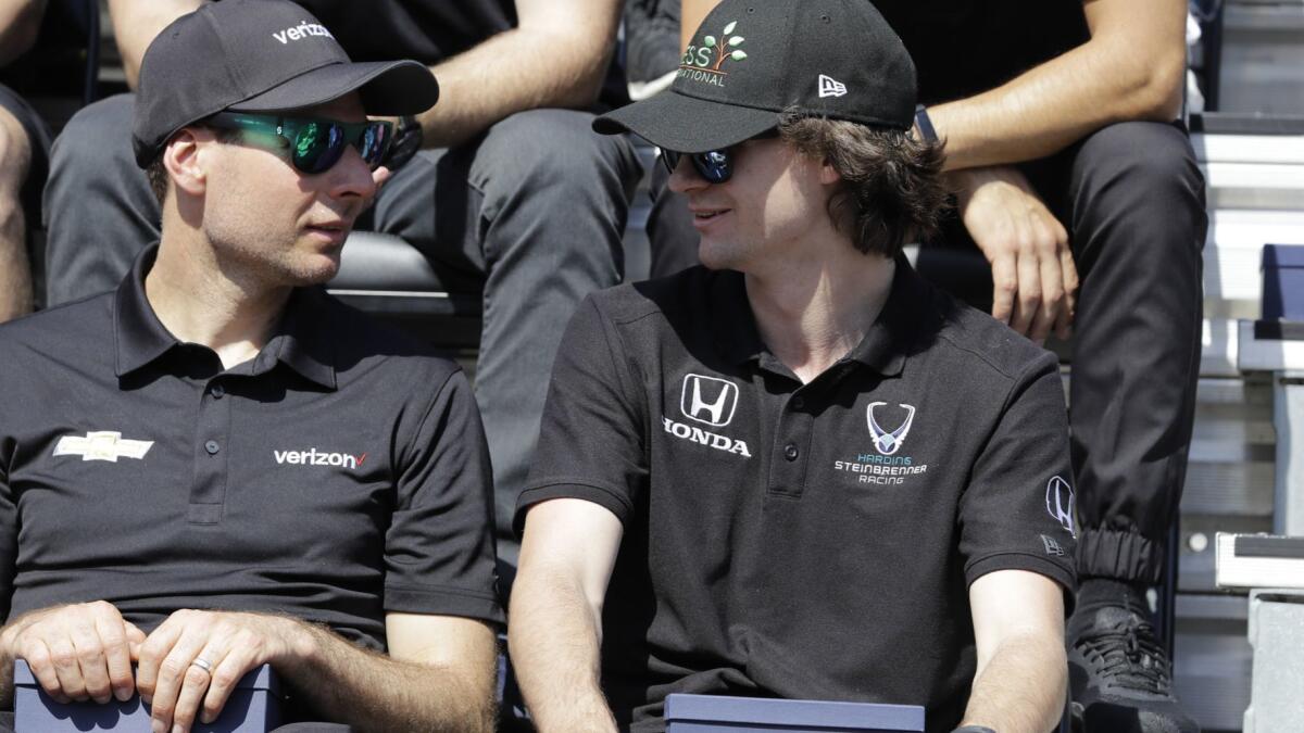 Colton Herta, right, chats with fellow IndyCar driver Will Power during the drivers meeting on Saturday.