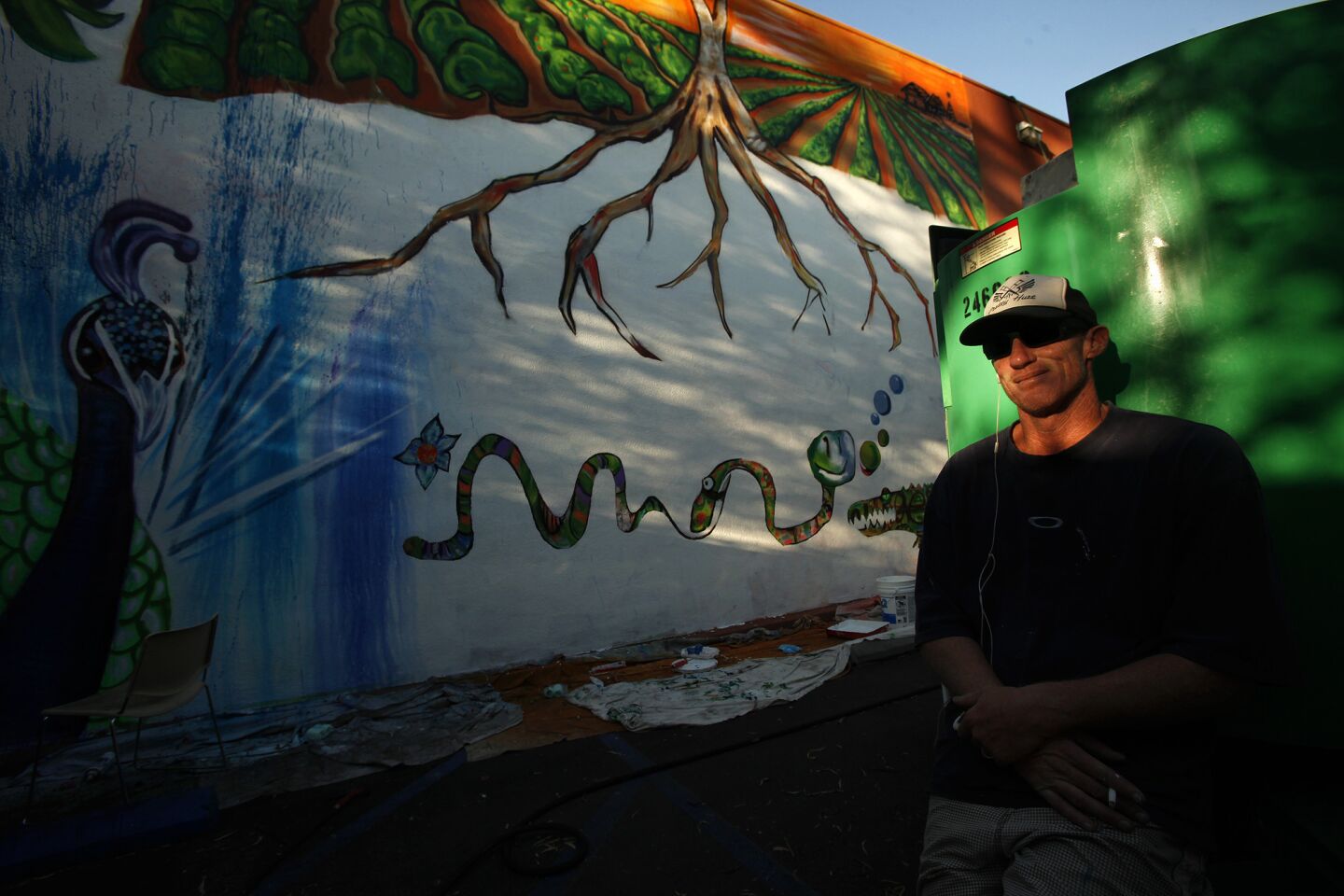Former USC and Los Angeles Raiders quarterback Todd Marinovich takes a break from painting his commissioned mural on the side of the GEM Theater in Garden Grove in 2014.