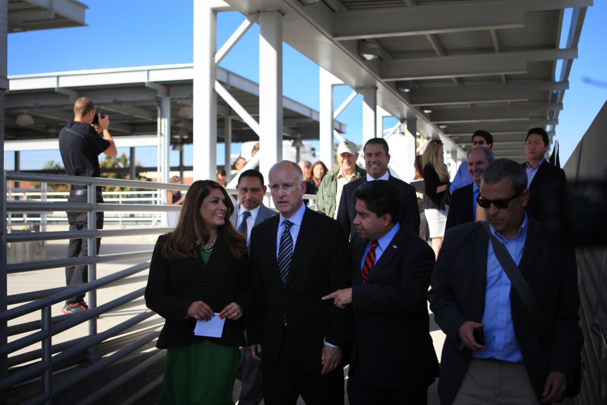 Assemblywoman Sharon Quirk-Silva (left) is joined Gov. Jerry Brown (center) at an event in Fountain Valley in October.