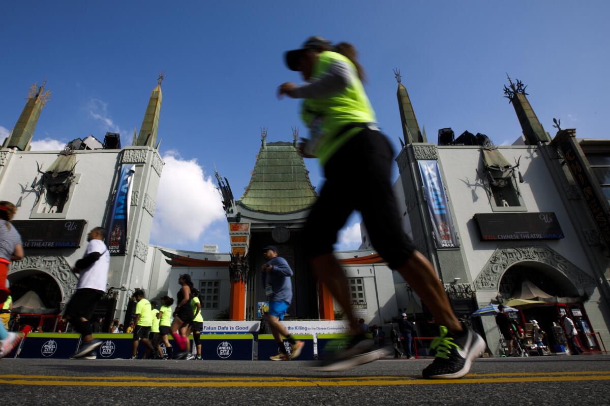 Participants run past the TCL Chinese Theatre on Hollywood Boulevard on Sunday.