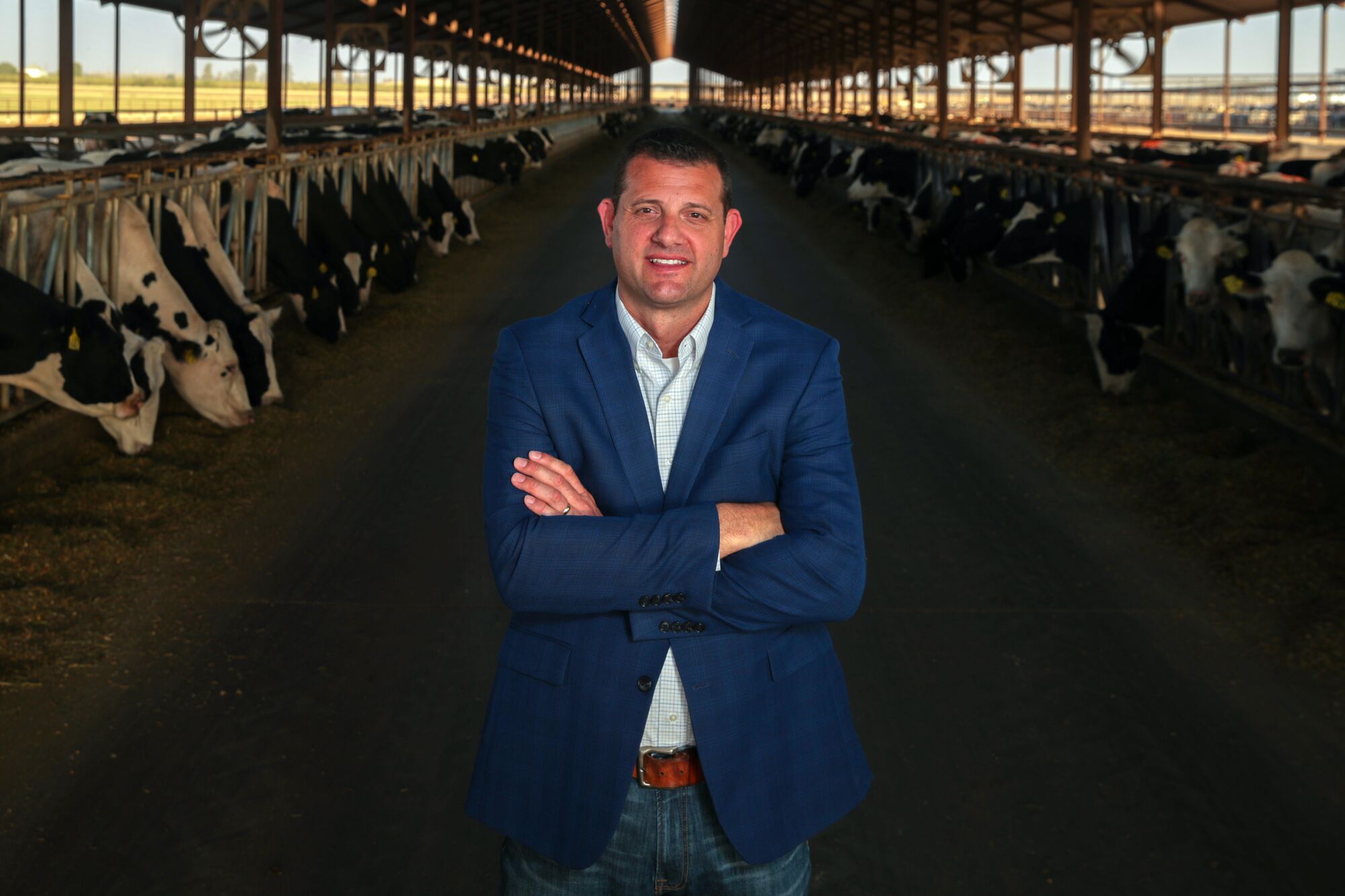 A farmworker’s son and a dairy farmer battle to represent the Central Valley in Congress 13 David Valadao stands in between lines of cows at his family's dairy operation.
