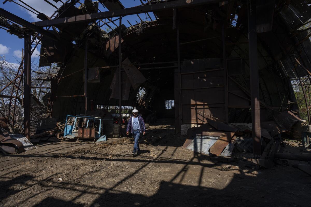 Ukrainian farmer Oleh Uskhalo walks inside a destroyed warehouse in Potomkyne, Kherson region