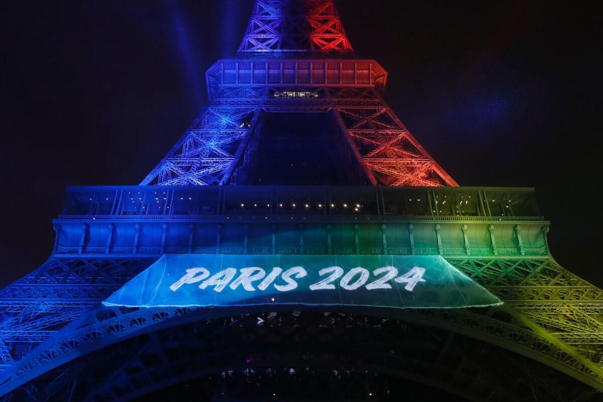 The Eiffel Tower displays the colors of the Olympic flag on Feb. 3 in Paris.