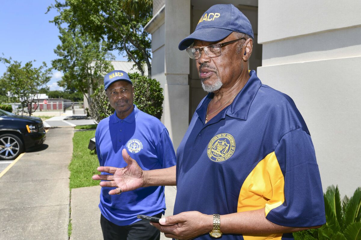 NAACP President Lewis Jennings, right, gives statement to the media Tuesday, June 7, 2022, in Fort Walton Beach, Fla., following the announcement that three Crestview Police officers were indicted for the October 2021 death of Calvin Wilks, Jr., who died hours after being tased during an incident with the officers. At left is Leroy Kelley, also with the NAACP. (Devon Ravine/Northwest Florida Daily News via AP)